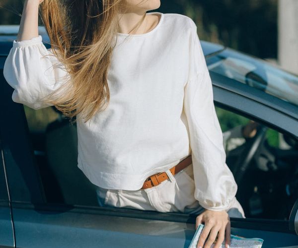 A person feeling joyful and refreshed outdoors after a workout.